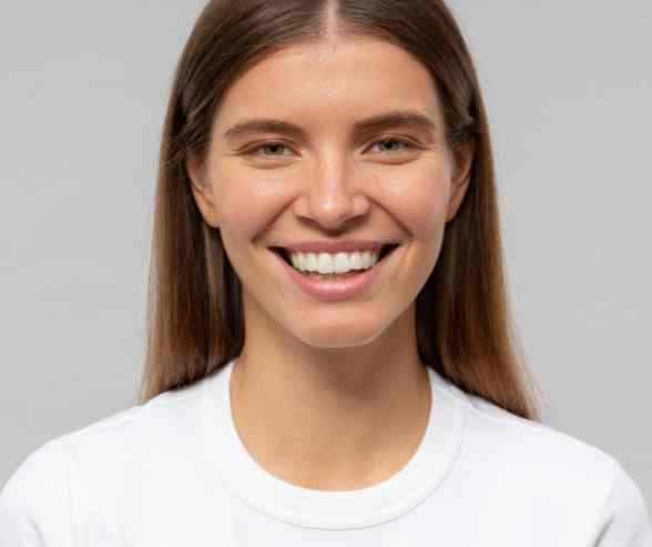 Patient showcasing a bright, white smile after professional dental whitening